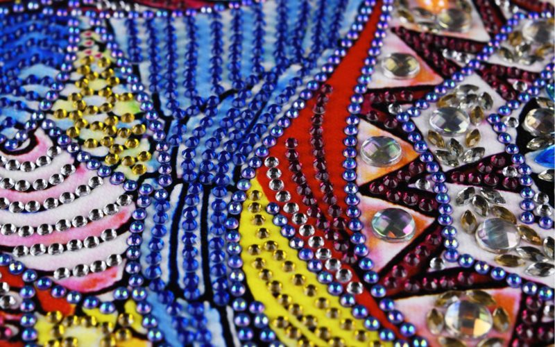 Evolution of diamond painting from blue, yellow, pink, and purple rhinestone mosaic