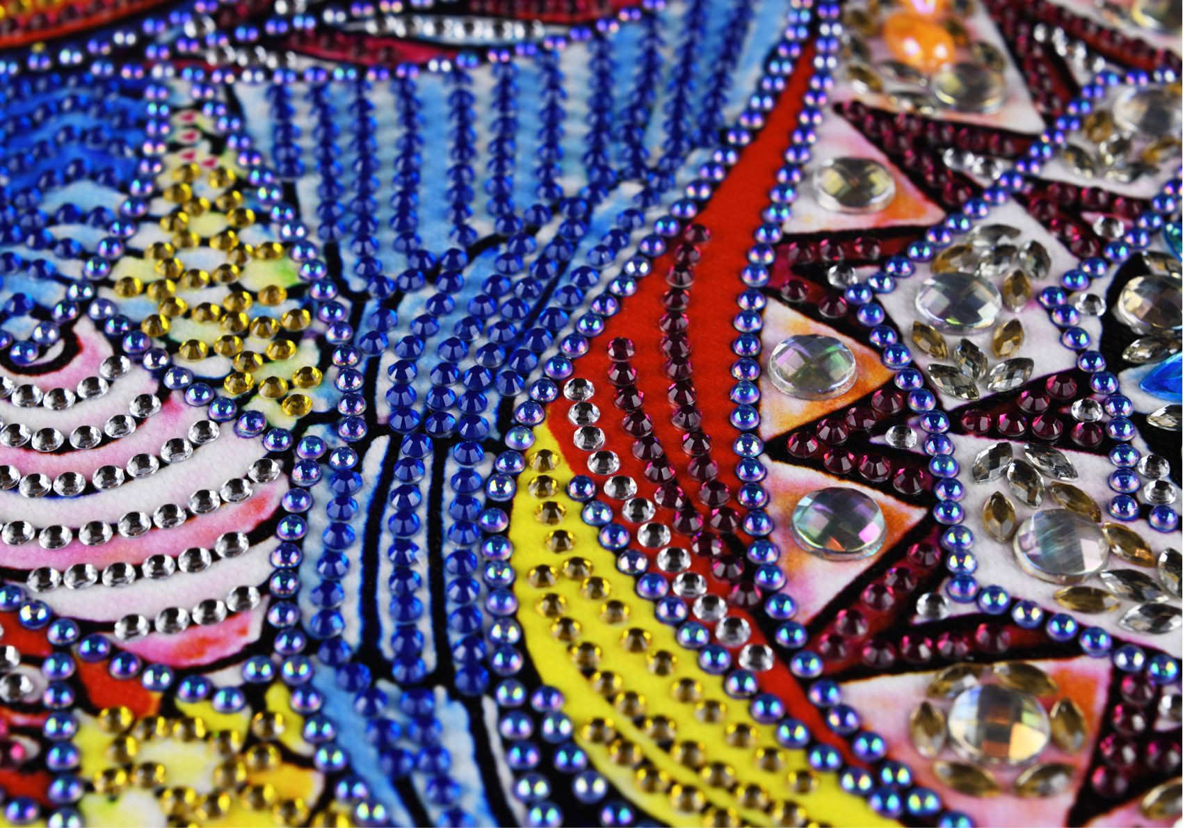 Evolution of diamond painting from blue, yellow, pink, and purple rhinestone mosaic