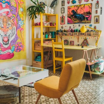 About businesses: image of desk with organized craft supplies and colorful wall art